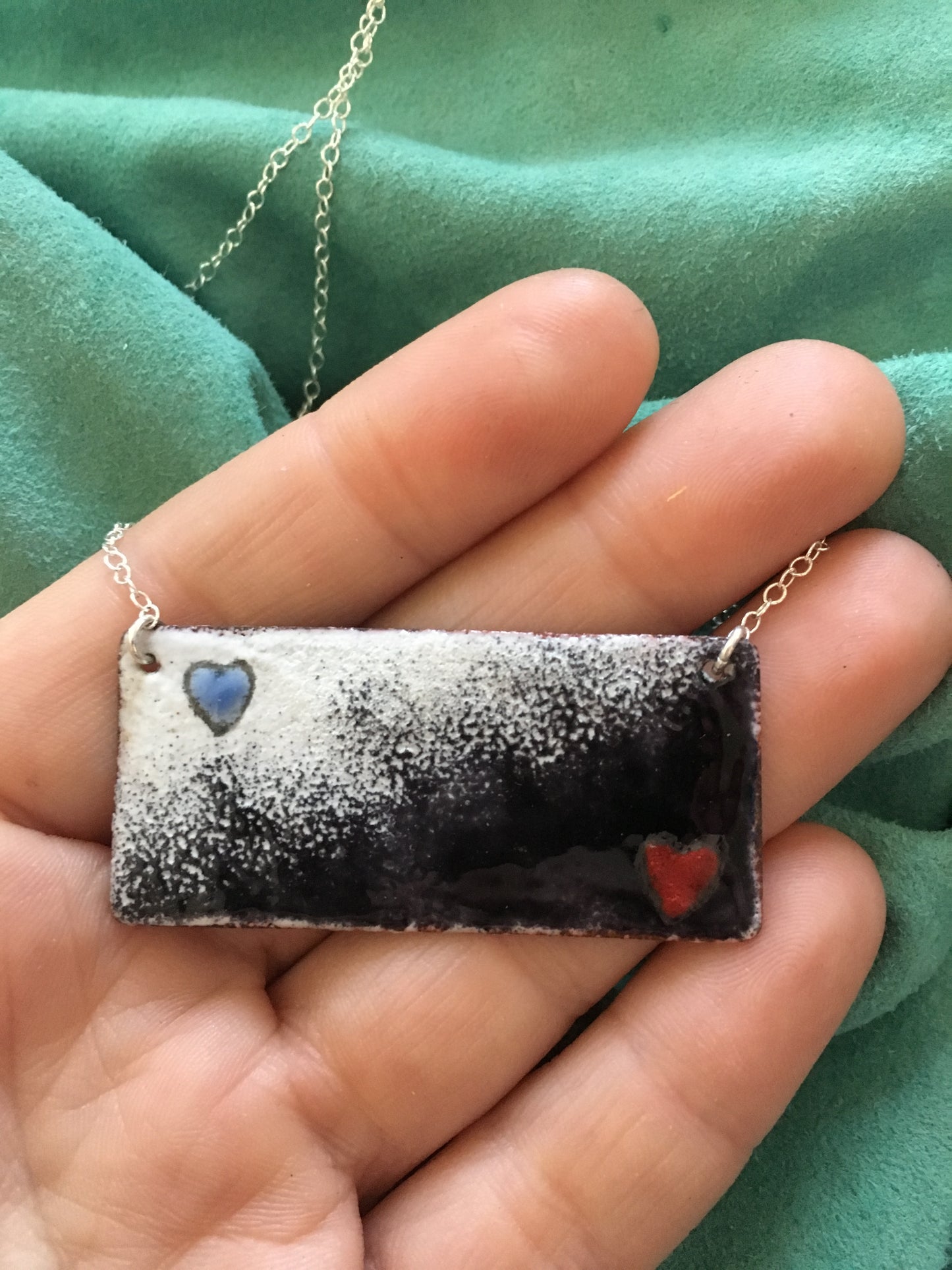 Harlequin Black and White enamel pendant with red and blue hearts