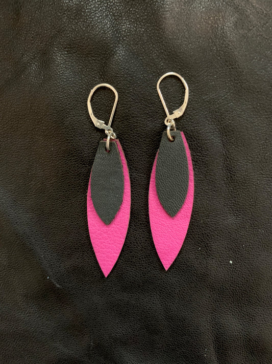 Feather shaped earrings with a layer of pink leather behind a smaller dark grey leather piece hanging from sterling silver lever back ear wires