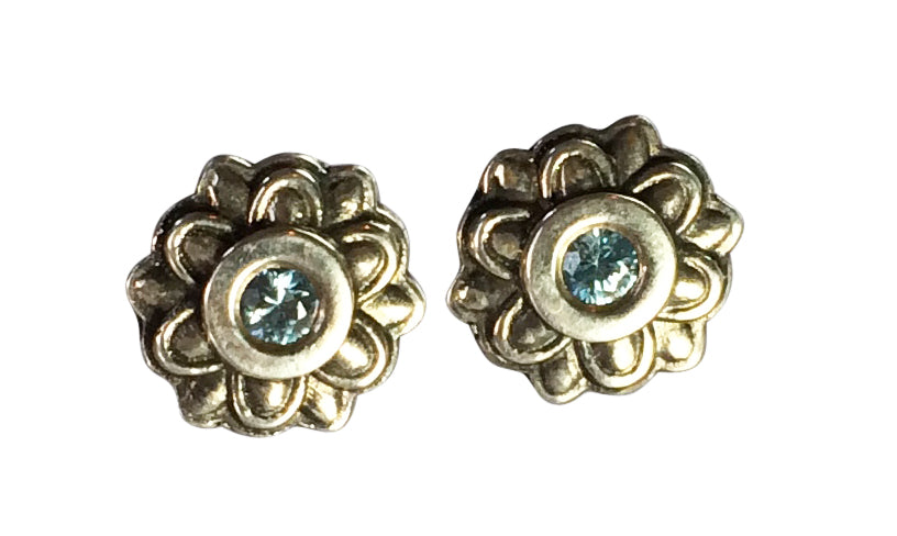 blue zircon round gemstones bezel set in round studs with a scalloped design on the edge